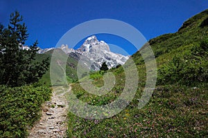 Path in the mountains. Mount Ushba, Main Caucasian ridge