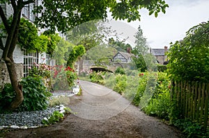 A path between Old cottages, timber frame houses in contryside photo