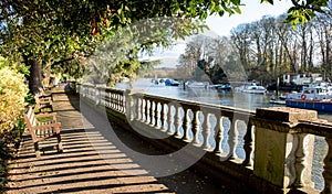 Path beside the River Thames at Twickenham, London UK, photographed in strong sun on a fine winter`s day.