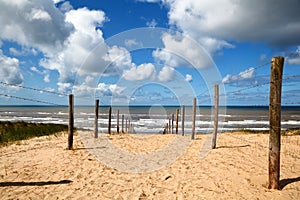 Path on sand to the beach on North sea