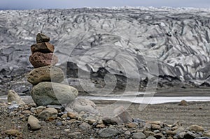 Path sign made with stones near a glacier