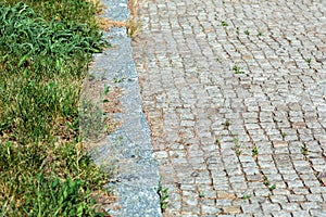 Path of square stone tiles with a curb.