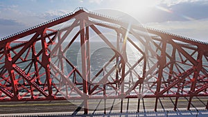 Path on the structural red bridge on a sunny day a little cloudy