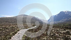 Path to Ben Nevis Scotland UK with snow topped mountains in the Grampians Lochaber Highlands pan