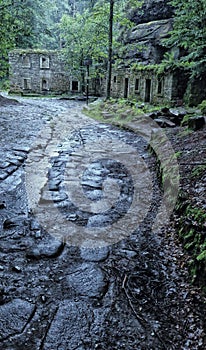 Path to the broken mill remains in the rain