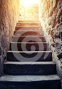 The path to success is represented by a 3D rendering of old concrete stairs ascending to the light