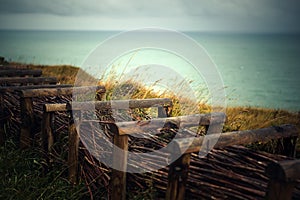 Path at the Top of the Cliffs at Fecamp Normany with wooden fence and barbed wire photo