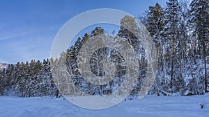 The path is trodden in a snow-covered valley.