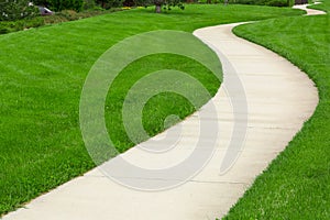 Pathway through green lawn photo