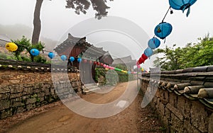 Pathway of Korean Buddhistic Temple Beomeosa with many lanterns to celebrate buddhas birthday on a foggy day. Located in Busan,