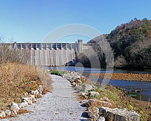 Pathway leading to Hydro-Electric Dams near a river surrounded by green trees