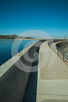 Pathway over dam wall forming a lake on highlands