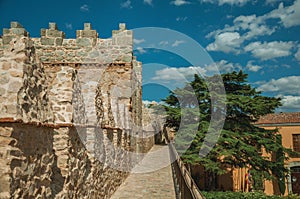 Pathway over old thick wall with large tower in Avila