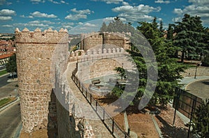 Pathway over old thick wall with large towers in Avila