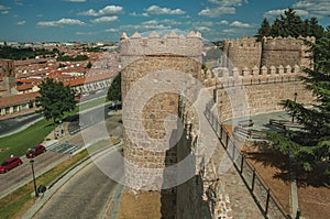 Pathway over old thick wall with large towers in Avila