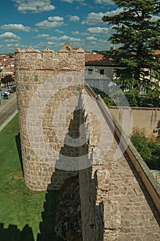 Pathway over old thick wall with large towers in Avila