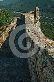 Pathway on stone wall with watchtower over ridge in Marvao