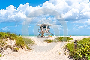 Pathway to the beach with Lifeguard hut and ocean on background in Fort Lauderdale, Florida USA