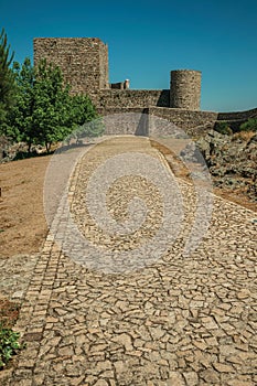 Pathway with trees going to wall and tower at the Marvao Castle