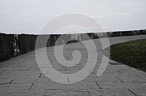 Pathway up the hill with a cloudy sky in the background