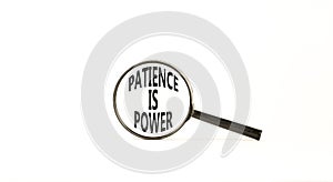 Patience is power symbol. Concept words Patience is power in beautiful magnifying glass. Beautiful white table white background.