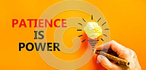 Patience is power symbol. Concept words Patience is power on beautiful orange paper. Beautiful orange background. Light bulb icon