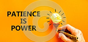 Patience is power symbol. Concept words Patience is power on beautiful orange paper. Beautiful orange background. Light bulb icon