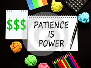 Patience is power symbol. Concept words Patience is power on beautiful white note. Beautiful black background. Black pen.