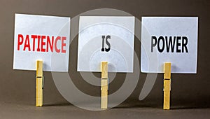 Patience is power symbol. Concept words Patience is power on beautiful white paper on clothespin. Beautiful grey table grey