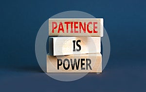 Patience is power symbol. Concept words Patience is power on beautiful wooden blocks. Beautiful grey table grey background.