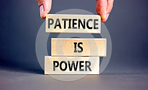 Patience is power symbol. Concept words Patience is power on beautiful wooden blocks. Beautiful grey table grey background.