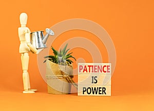 Patience is power symbol. Concept words Patience is power on beautiful wooden blocks. Beautiful orange table orange background.