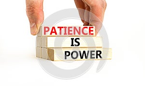 Patience is power symbol. Concept words Patience is power on beautiful wooden blocks. Beautiful white table white background.