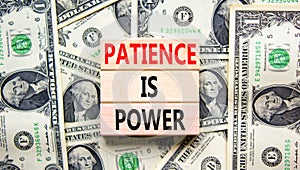 Patience is power symbol. Concept words Patience is power on beautiful wooden blocks. Dollar bills. Beautiful dollar bills