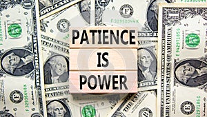 Patience is power symbol. Concept words Patience is power on beautiful wooden blocks. Dollar bills. Beautiful dollar bills