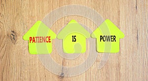 Patience is power symbol. Concept words Patience is power on beautiful yellow paper houses. Beautiful wooden table wooden