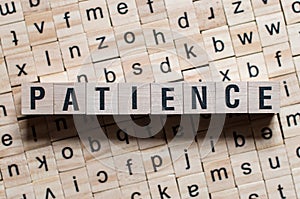 PATIENCE word written on wood block