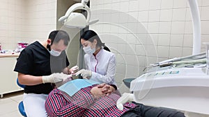 Patient an appointment at the dentist and nurses. the treatment of the oral