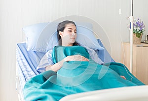 Patient asian woman sleeping under blanket on sickbed at the hospital