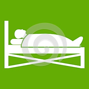 Patient in bed in hospital icon green