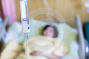 Patient on the bed with saline drip photo