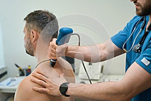 Patient being treated for dorsodynia by physical therapist in clinic