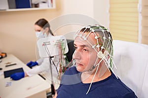 Patient brain testing using encephalography at medical center