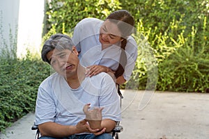 The patient is Cerebrovascular accident or stroke Caused by hypertension and obesity, sitting in wheelchair him mouse is facial pa