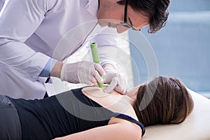 The patient in clinic undergoing laser scar removal