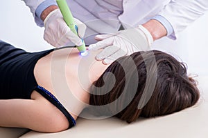 The patient in clinic undergoing laser scar removal