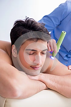 The patient in clinic undergoing laser scar removal