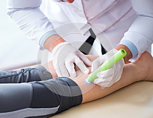 Patient in clinic undergoing laser scar removal