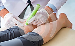 Patient in clinic undergoing laser scar removal