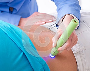 Patient in clinic undergoing laser scar removal